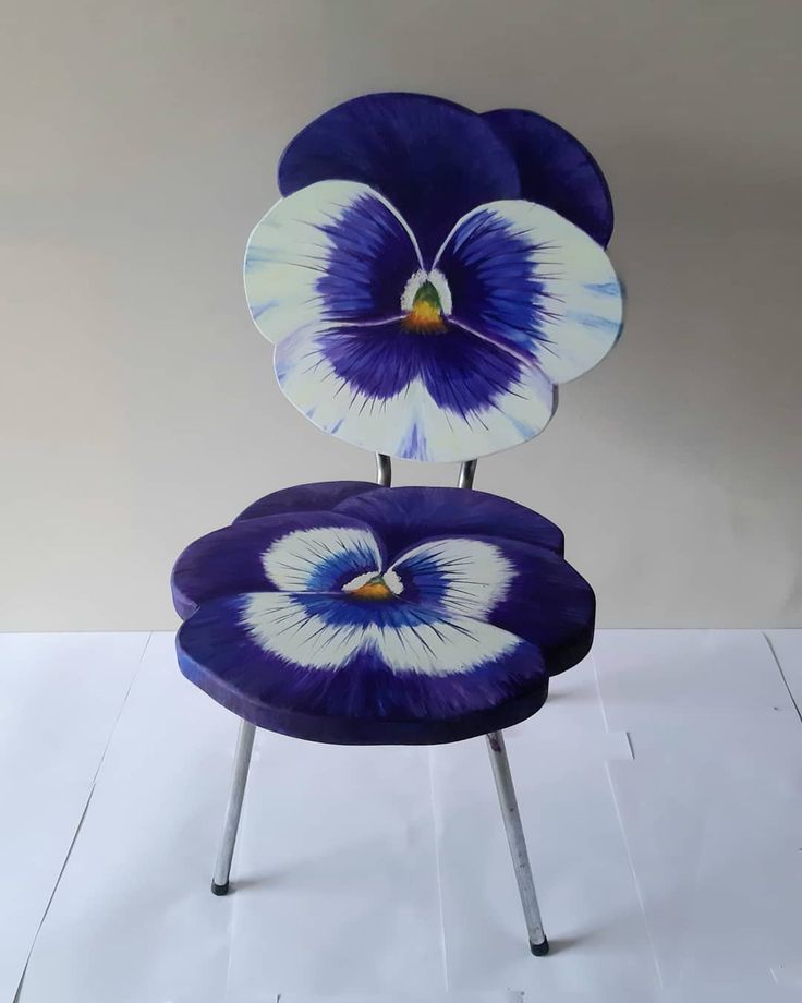 three blue and white flower shaped chairs stacked on top of each other