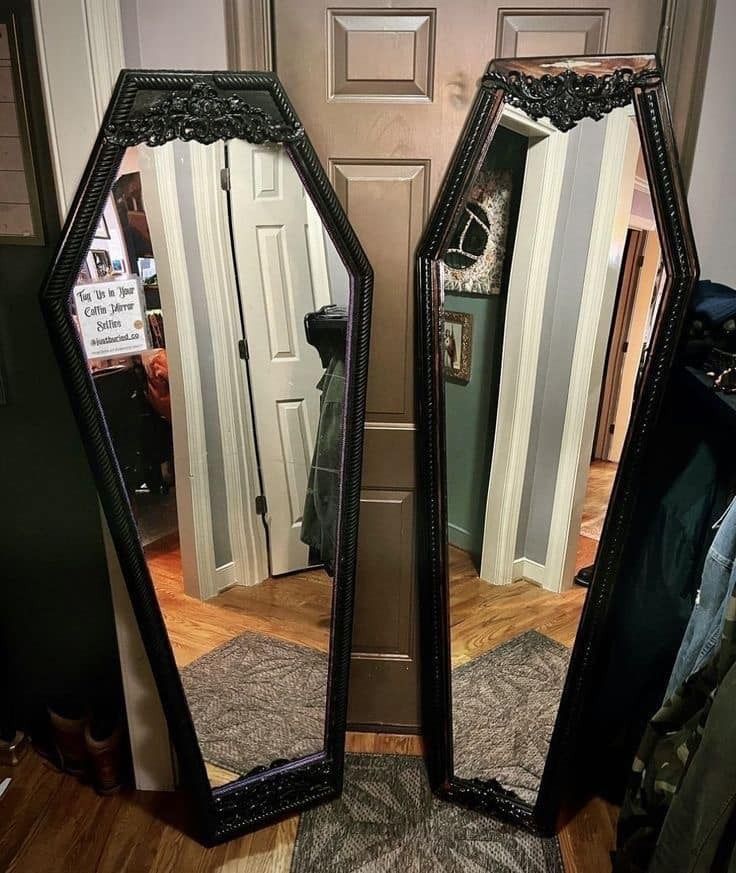 two mirrors sitting on top of a wooden floor next to each other in front of a door