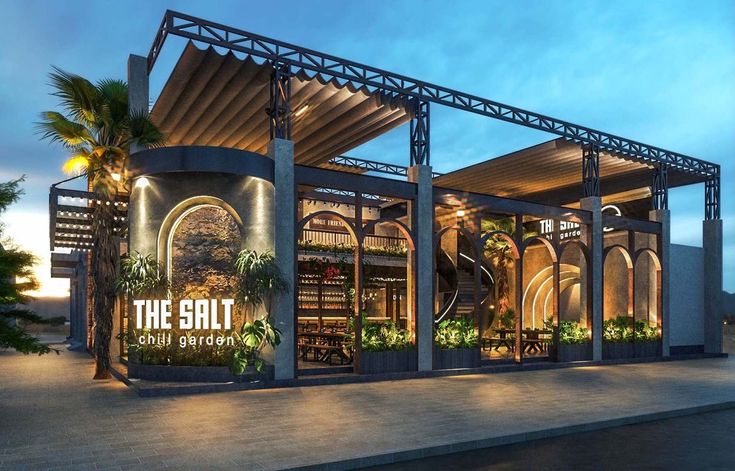 the salt restaurant is lit up at night with palm trees and lights on it's sides