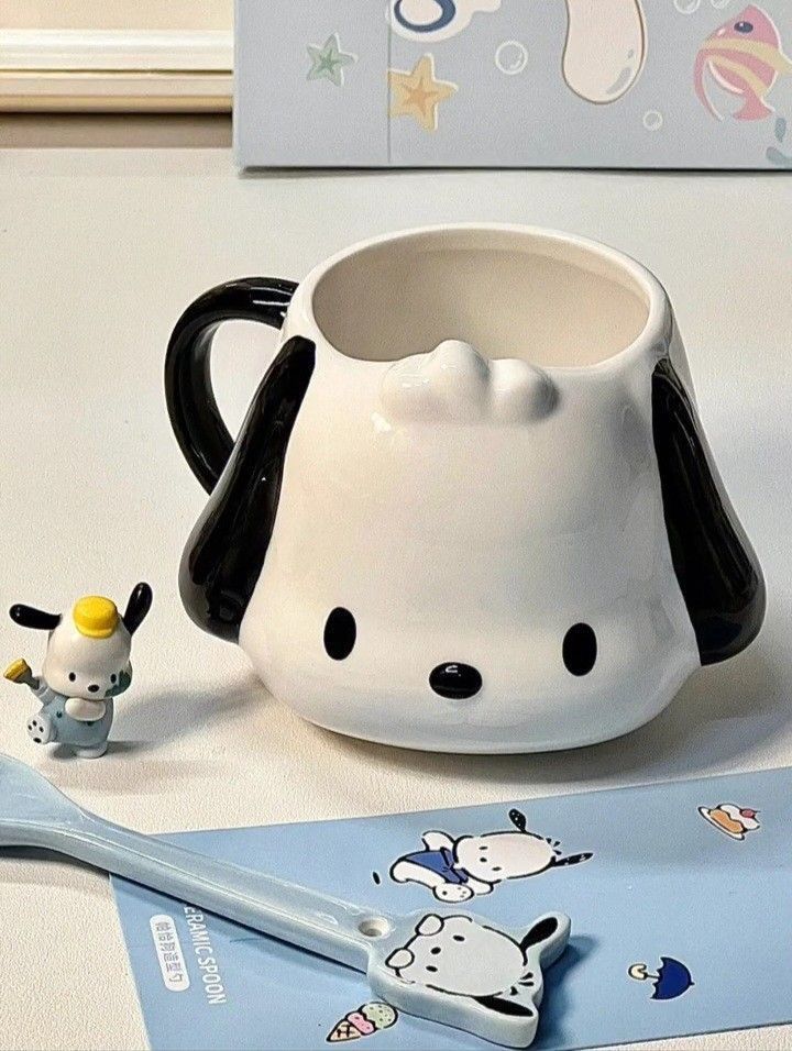 a white and black dog mug next to a toothbrush on a table with other items