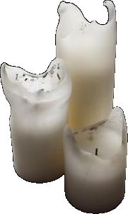 three white candles sitting next to each other