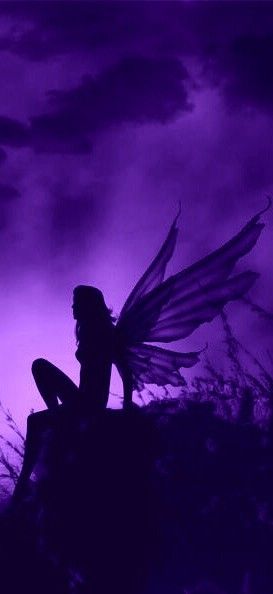 a fairy sitting on top of a hill under a purple sky