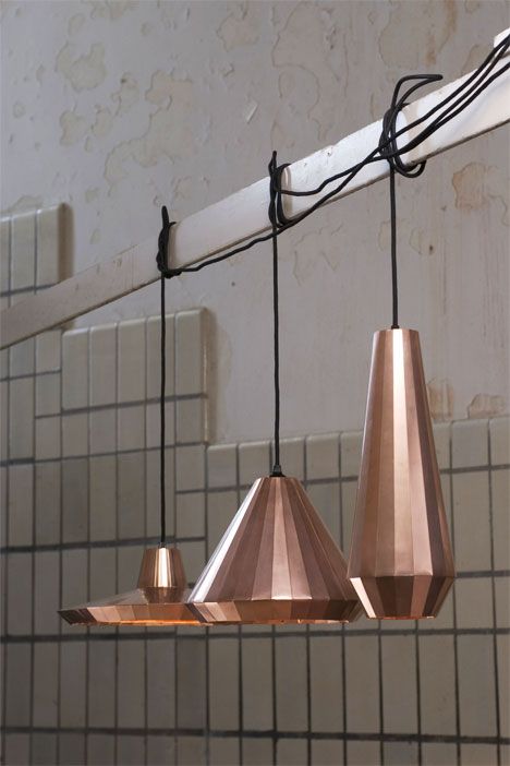 three copper colored lights hanging from the ceiling