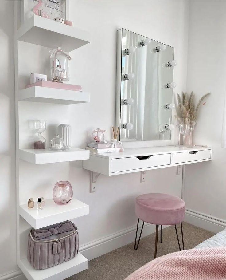 a bedroom with a vanity, stool and mirror on the wall next to a bed