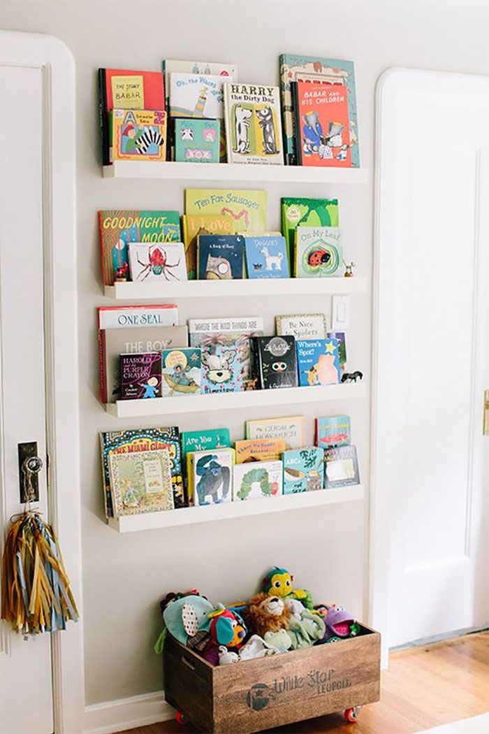 the bookshelf is filled with children's books