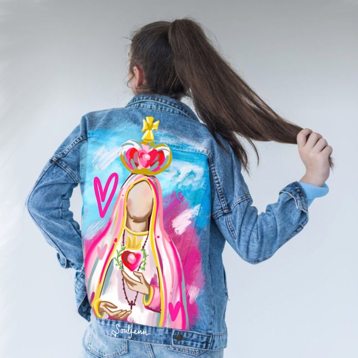 a woman wearing a jean jacket with an image of a princess on the front and back