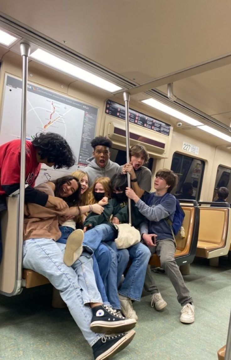 a group of people sitting on a subway car