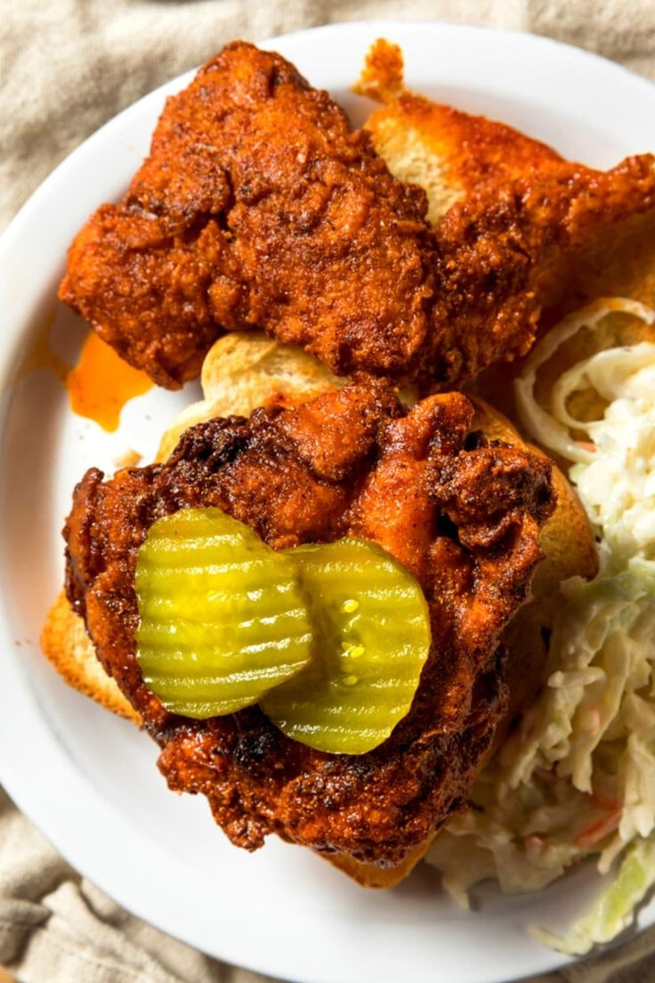 fried chicken with pickles and macaroni and cheese on a plate