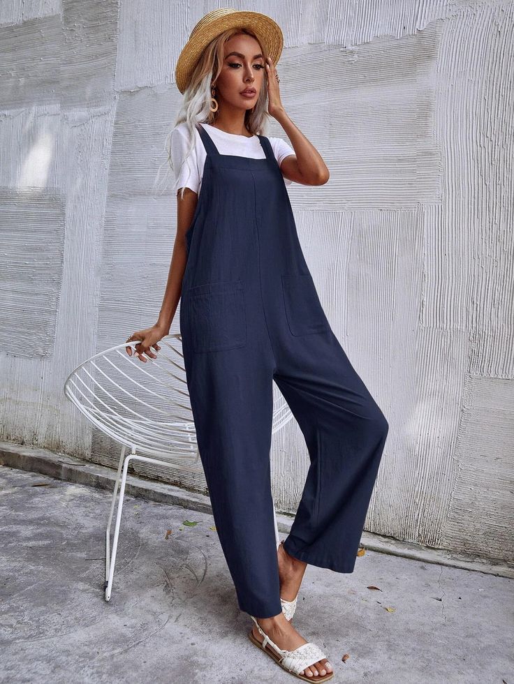 This Dual Pocket Sleeveless Jumpsuit is the perfect combination of comfort and style. Crafted from a lightweight fabric blend with a slight stretch, this jumpsuit offers you optimal breathability and flexibility. The stylish letter pattern gives it an edgy look, while the dual pocket design adds practicality to your everyday outfit. It also features a collared neckline, short sleeves, and a short length that provides coverage without sacrificing fashion. This jumpsuit is sure to keep you comfortable all day long in any season! Features: Color: Navy Blue Style: Casual Pattern Type: Plain Type: Overall Details: Button, Pocket Length: Long Fit Type: Regular Fit Neckline: Straps Sleeve Length: Sleeveless Waist Line: Natural Fabric: Non-Stretch Material: Fabric Body: Unlined Sheer: No Size Char Sleeveless Summer Leisure Jumpsuits And Rompers, Sleeveless Summer Jumpsuits And Rompers For Leisure, Trendy Summer Jumpsuits And Rompers For Leisure, Summer Sleeveless Jumpsuits And Rompers With Pockets, Sleeveless Summer Jumpsuits And Rompers With Pockets, Casual Solid Color Overalls Romper, Summer Cotton Jumpsuits And Rompers For Leisure, Comfortable Leisure Overalls And Rompers, Sleeveless Jumpsuits And Rompers For Leisure