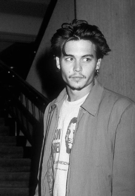 a man standing in front of some stairs