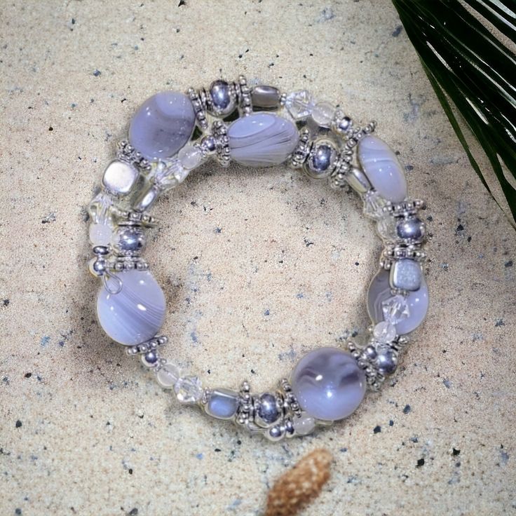 Beautiful Grey and white glass bead bracelet. Cool beach feeling. Very pretty in person. Good weight! Perfect for anyone! Silver Beaded Stretch Bracelet For The Beach, Handmade White Stretch Strand Bracelet, Silver Adjustable Strand Beaded Bracelets, Adjustable Silver Beaded Strand Bracelets, White Hand Wrapped Crystal Bracelet With Round Beads, Hand Wrapped White Crystal Bracelet With Round Beads, Silver Hand-wrapped Bracelets For Beach, Silver Hand-wrapped Bracelet, Bohemian Round Stretch Bracelet For Beach