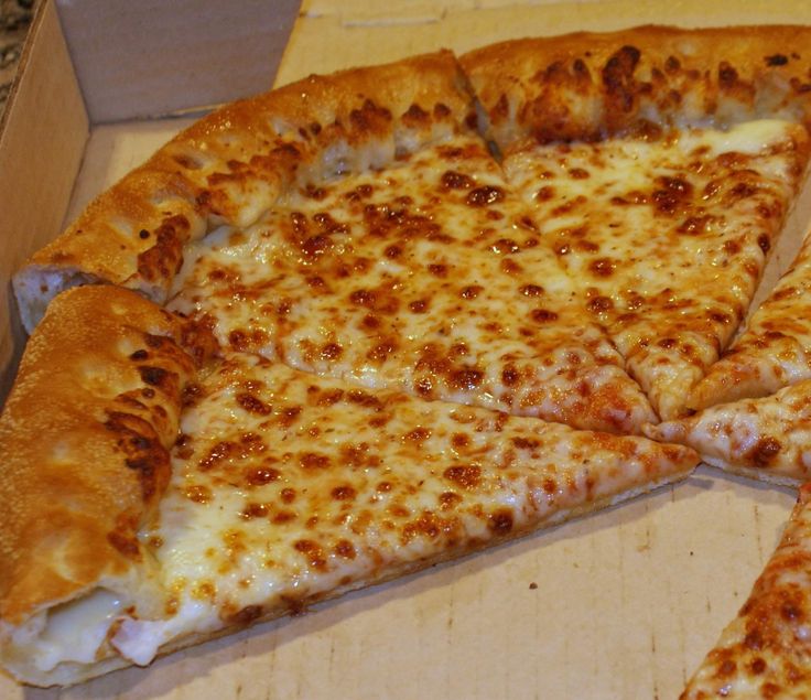 a pizza sitting in a box on top of a counter