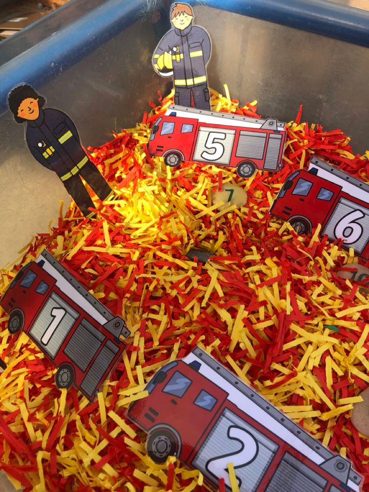 the fire truck is made out of shredded red paper and yellow crepe paper