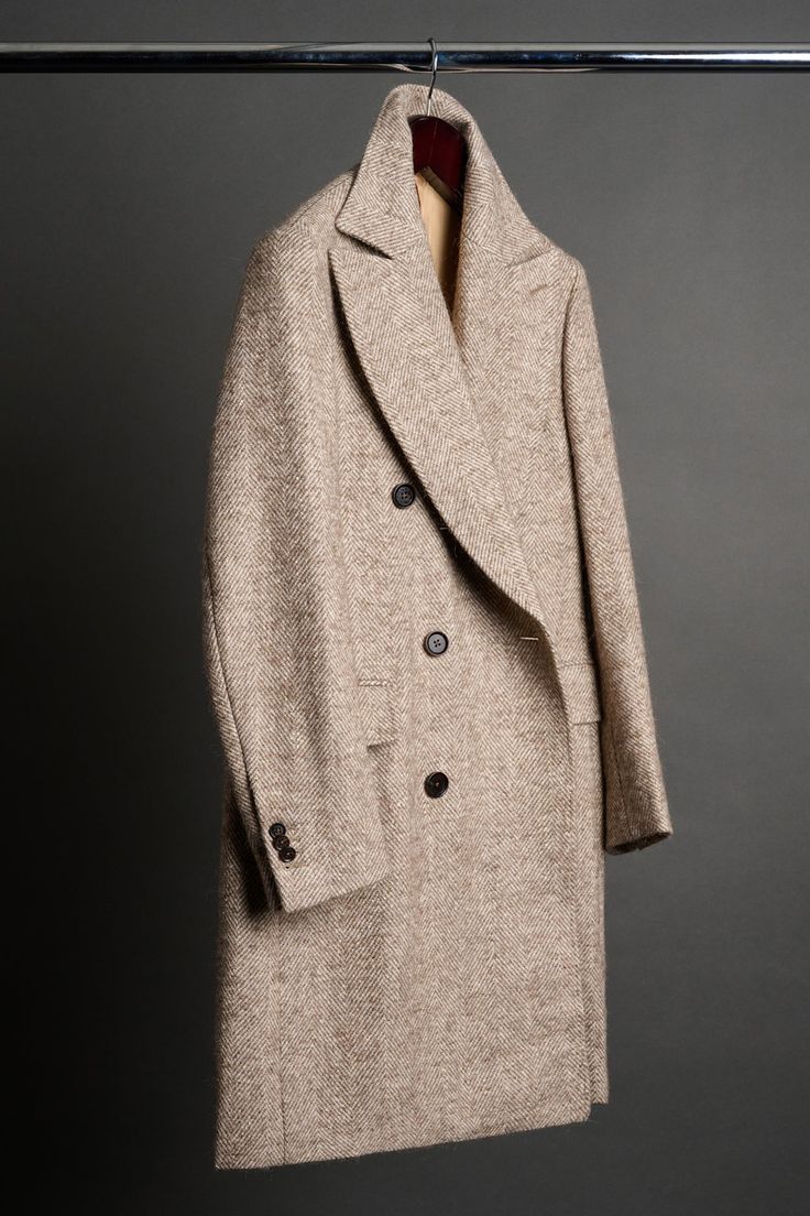 A handmade bespoke overcoat crafted from a luxurious fabric with a unique blend of fibers (wool, alpaca, mohair, silk and nylon) to give you the ultimate do-it-all coat. Wool gives it lasting performance and versatility. Alpaca gives it softness and warmth. Mohair gives it a crisp drape with natural wrinkle-resistance. Silk gives it a luster and natural sheen. And nylon gives it strength and durability to last the test of time. You will love this coat - it will elevated your entire wardrobe and you will wear it for many years to come. Formal Neutral Wool Outerwear, Neutral Long Wool Coat, Luxury Neutral Outerwear For Formal Events, Luxury Neutral Outerwear For Formal Occasions, Beige Long Wool Coat With Concealed Placket, Beige Wool Coat For Winter Tailoring, Beige Wool Coat With Hidden Buttons, Neutral Wool Outerwear With Notch Lapel, Elegant Neutral Wool Outerwear