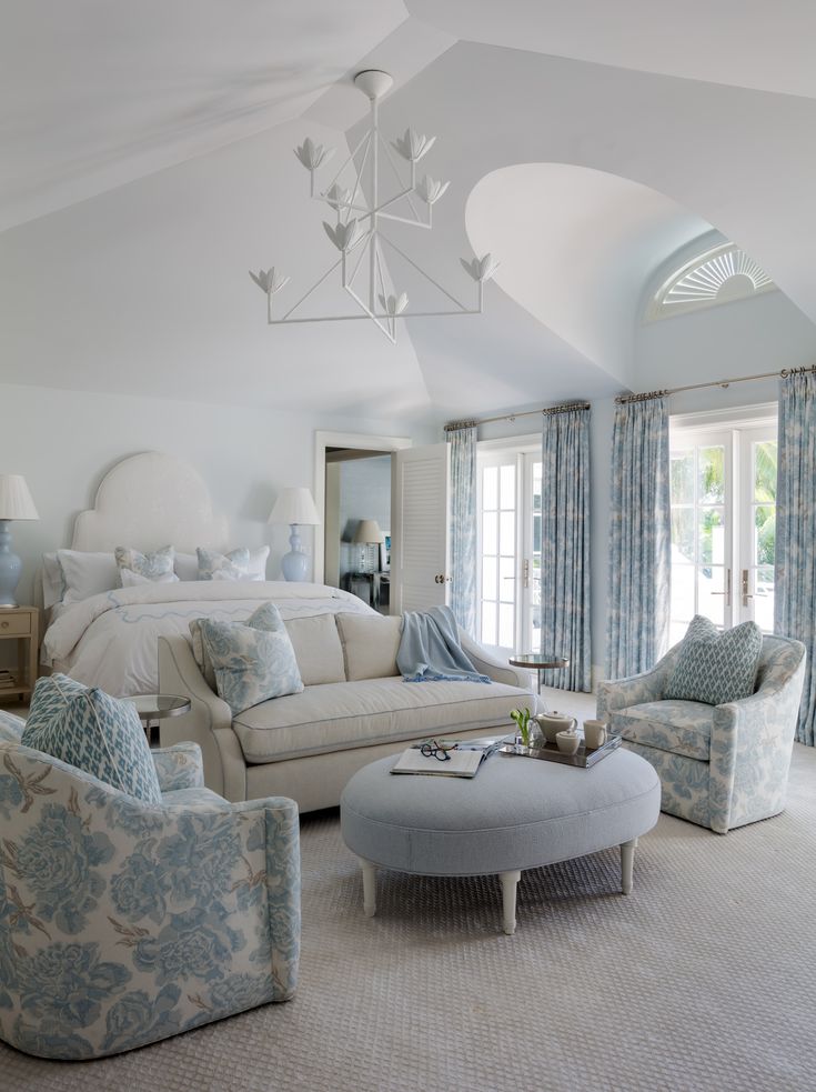 a living room filled with furniture and a chandelier