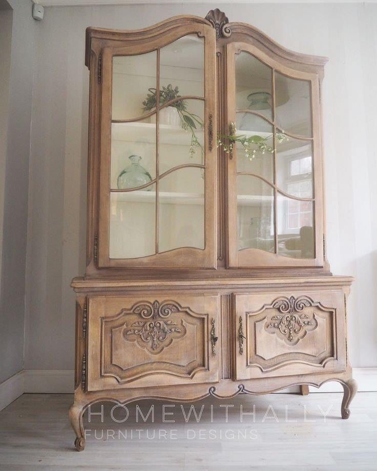 an antique china cabinet with glass doors