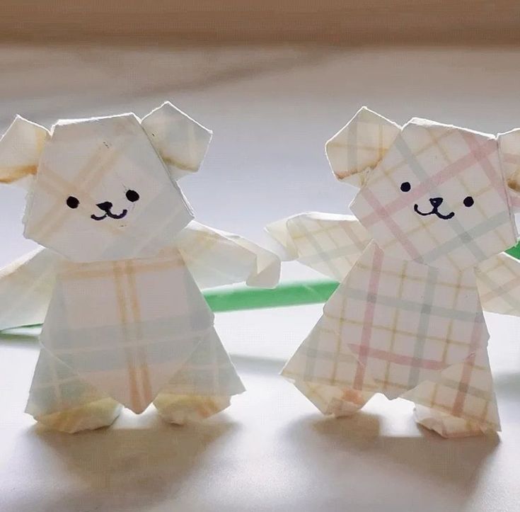 two origami bears are standing next to each other