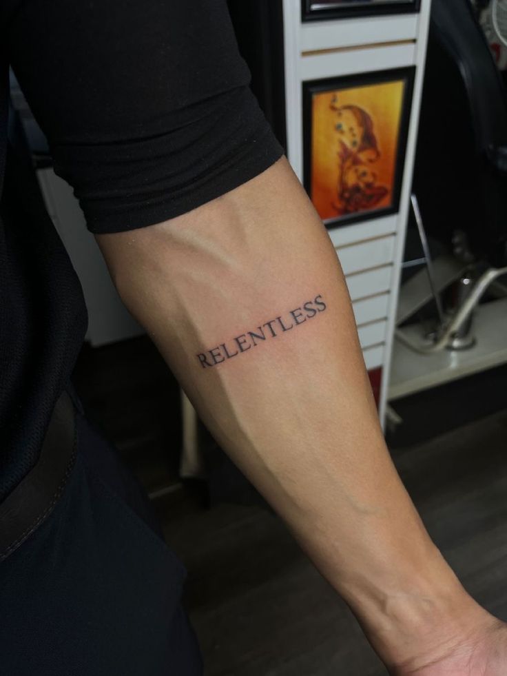 a man with a tattoo on his arm that says,'reentless '