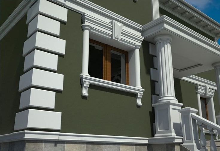 a green building with white trim and windows