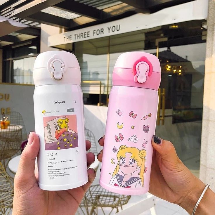 two pink and white water bottles with cartoon characters on them