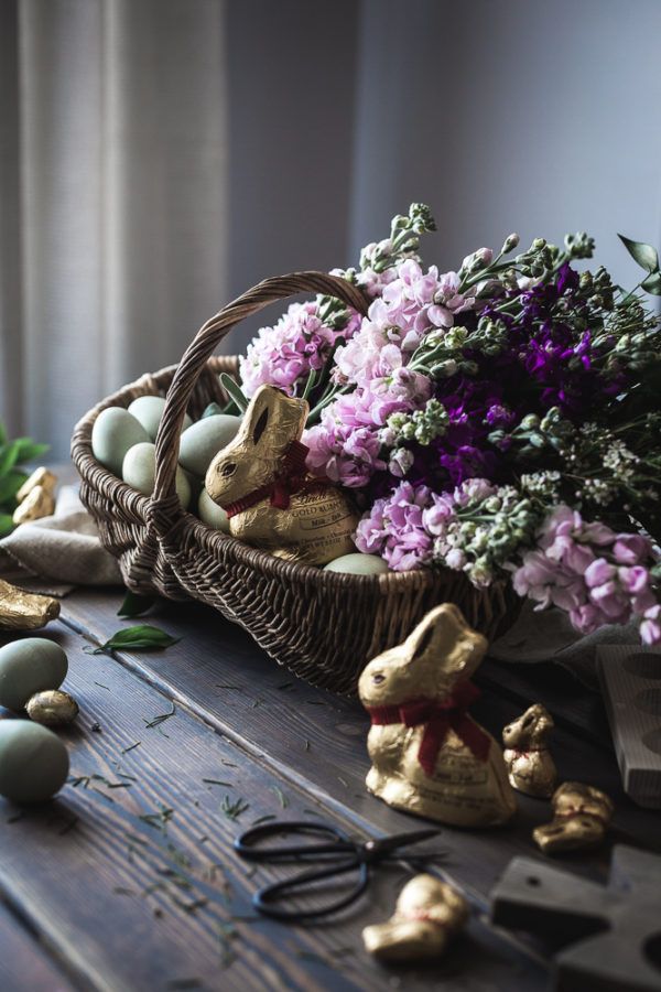 an easter basket filled with eggs and flowers