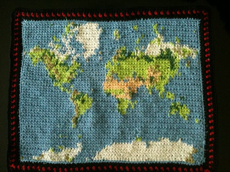 a crocheted map of the world is shown on a blue background with red trim