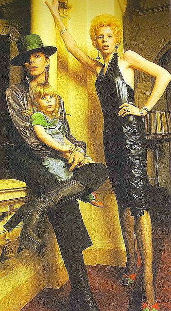 a man, woman and child posing for a magazine cover