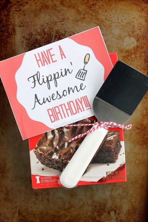 a piece of cake and a knife on top of a card that says have a flippin'awesome birthday