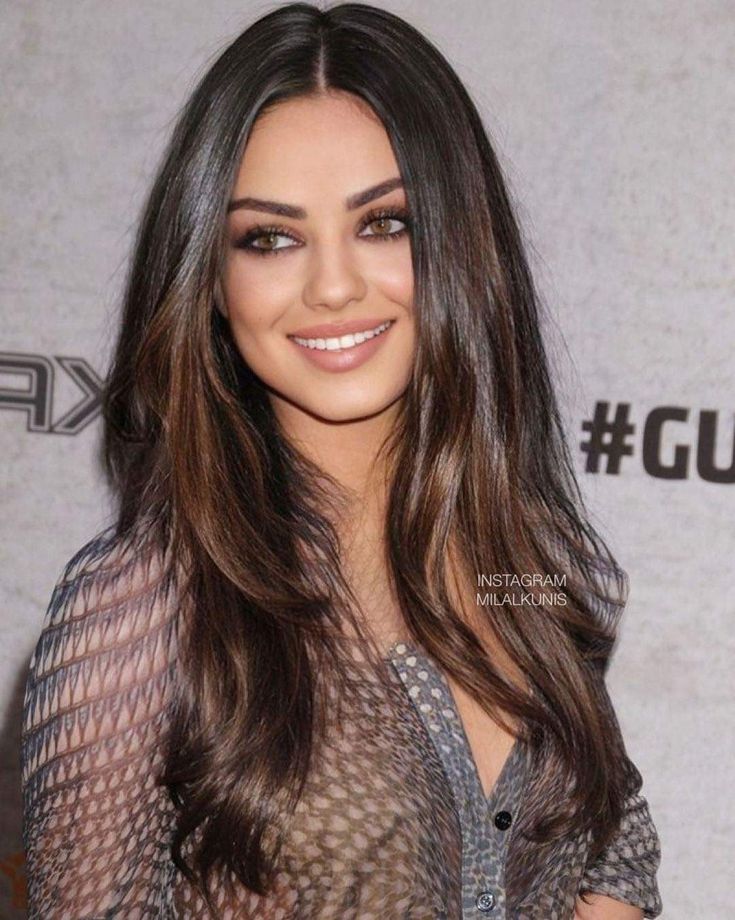 an image of a woman with long hair smiling at the camera and wearing sheer clothing