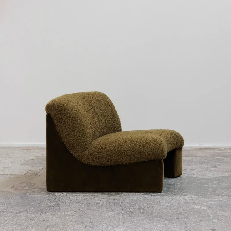 a brown chair sitting on top of a cement floor