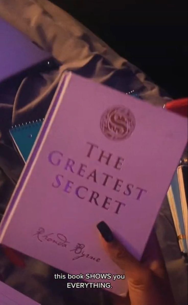 a person holding up a book in their hand with the title, the greatest secret