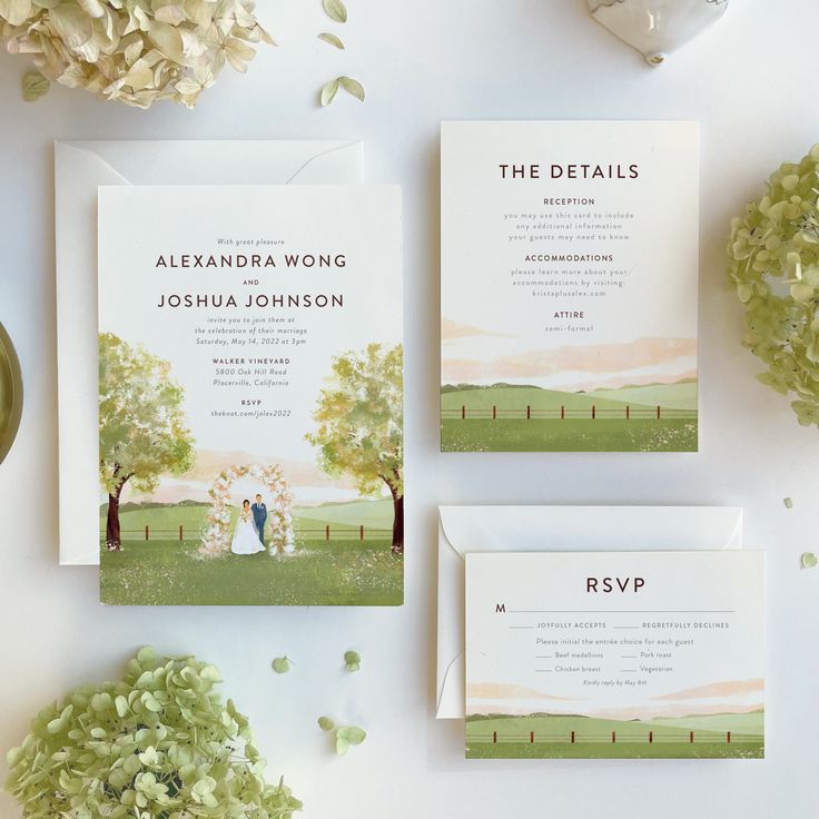 the wedding stationery is laid out on top of the table with flowers and greenery