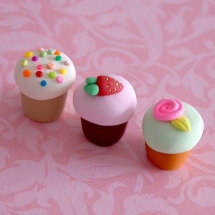 three small cupcakes on a pink tablecloth