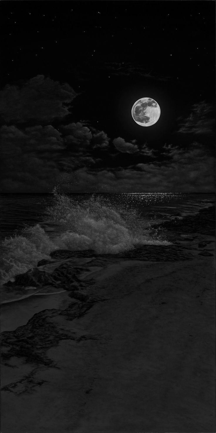 a full moon is seen over the ocean with waves crashing in front of it and dark clouds