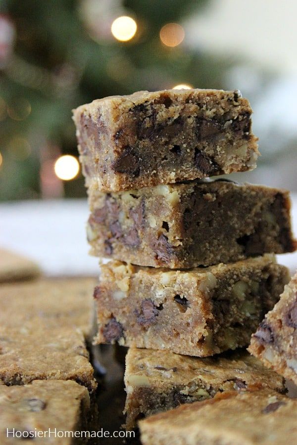 three pieces of brownies stacked on top of each other in front of a christmas tree