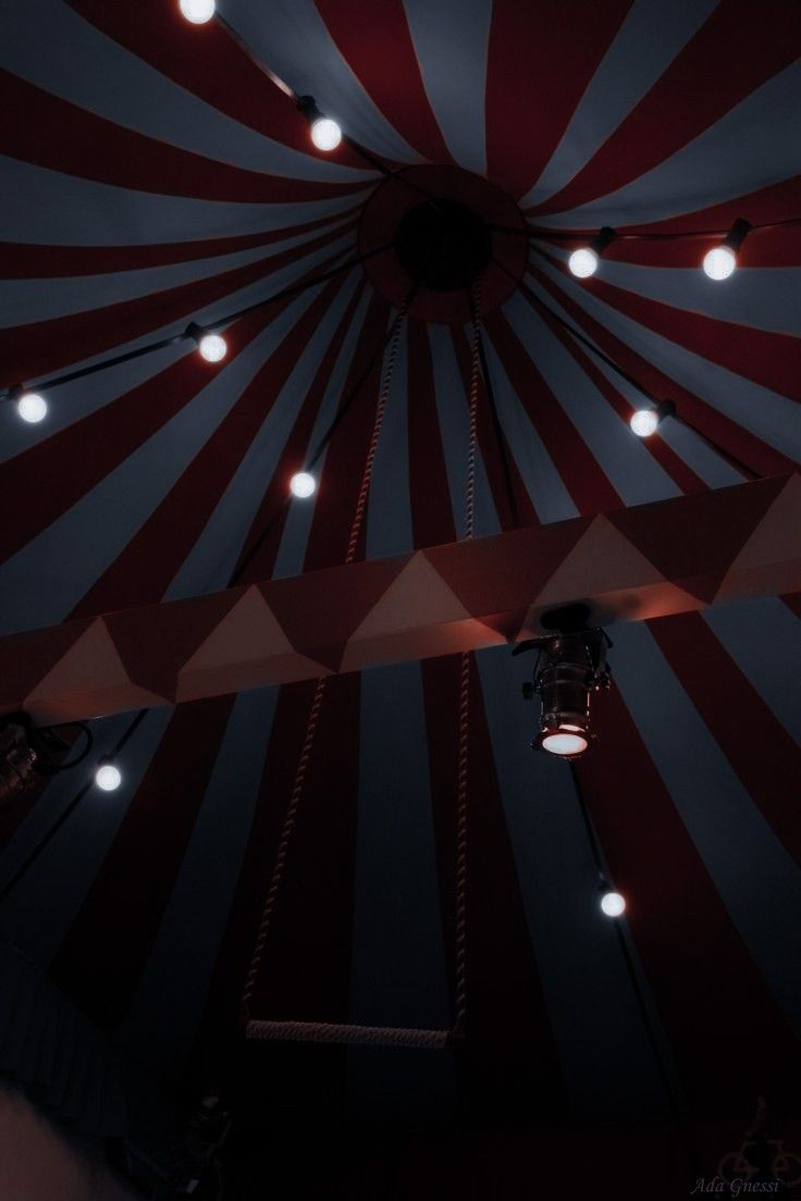 a large tent with lights hanging from it's ceiling