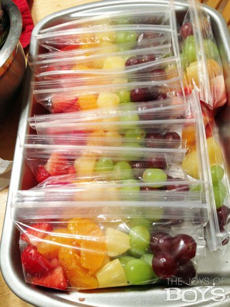 several plastic containers filled with different types of fruit