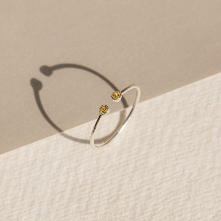 The Tiny Dual Birthstone Ring is our daintier, more petite counterpart of the Dual Birthstone Ring. It's the cutest way to feel connected to your birthstone and commemorate your special bond with another! Material: High-Quality Solid 925 Sterling Silver Stone Dimensions: 2mm Genuine CZ Gemstone Finish: Sterling Silver ∙ 18K Gold ∙ Rose Gold SKU: MM-RM05a Sizing Guide Rings are created true to standard US sizing. For the best fit we suggest having your finger(s) sized. We offer a physical ring si Adjustable White Gold Birthstone Open Ring, Adjustable White Gold Open Birthstone Ring, Sterling Silver Open Ring Birthstone Ring, Adjustable Dainty Birthstone Open Ring, Everyday Sterling Silver Birthstone Ring With Open Ring Shape, Minimalist Sterling Silver Birthstone Ring For Anniversary, Adjustable Open Birthstone Ring For Anniversary, Adjustable Birthstone Midi Rings In Fine Jewelry Style, Adjustable Sterling Silver Open Birthstone Ring