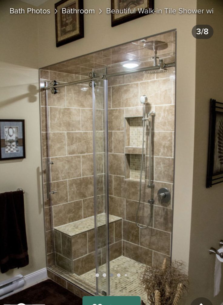 a bathroom with a walk in shower next to a toilet