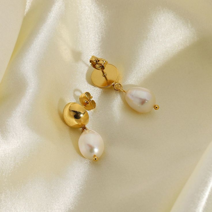 Indulge in the classic beauty of Pearl Drop Earrings, elegantly crafted in 18k gold plating. These earrings feature lustrous pearls that gracefully dangle, adding a touch of timeless sophistication to any attire. Classic Pear-shaped Gold Earrings, Tarnish-resistant Pearl Drop Earrings, Classic Drop Earrings With Pearl Chain, Gold Plated Tarnish Resistant Pearl Earrings, Gold-plated Tarnish-resistant Pearl Earrings, Tarnish Resistant Gold Plated Pearl Earrings, Elegant 14k Gold Filled Earrings With Pearl Charm, Elegant 14k Gold-filled Earrings With Pearl Charm, Elegant Pearl Charm Earrings In 14k Gold Filled