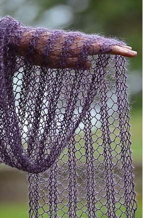 a purple net hanging from the side of a tree