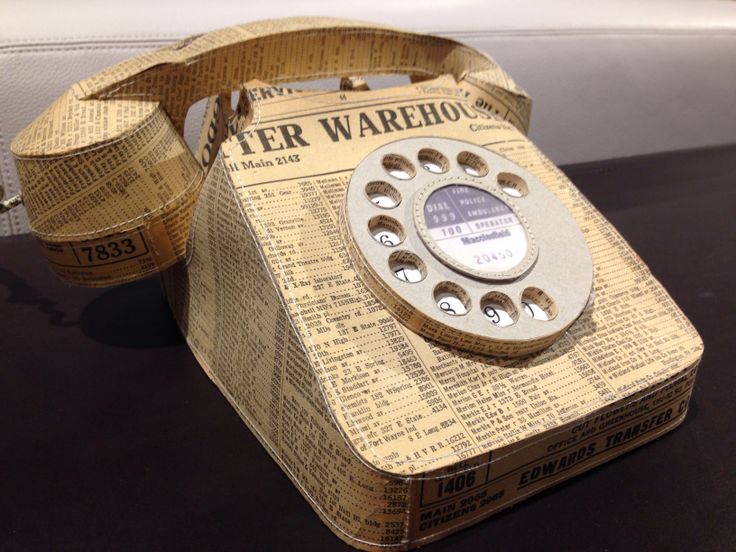 an old fashioned phone made out of newspaper