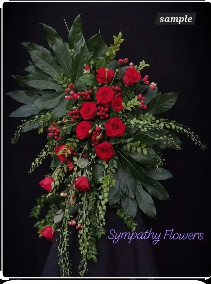 a bouquet of red roses and greenery with the words sympathy flowers written below it