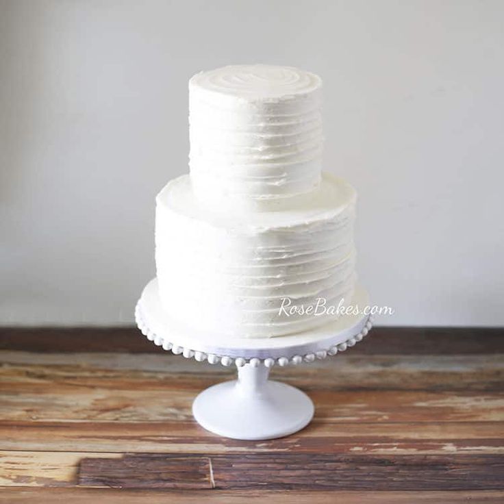 a white cake sitting on top of a wooden table