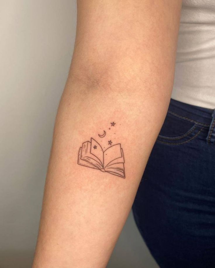 a woman with a book tattoo on her arm