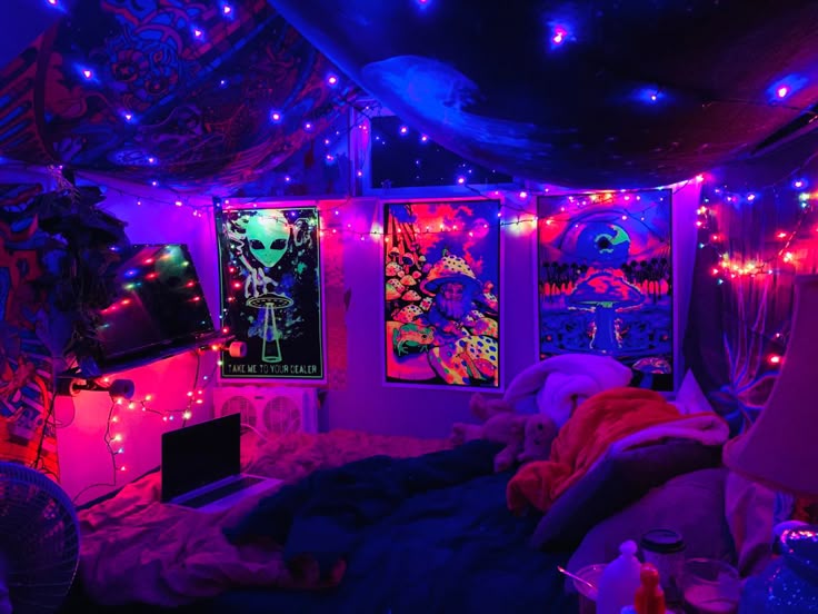 a bedroom decorated in purple and blue lights with pictures on the wall above the bed