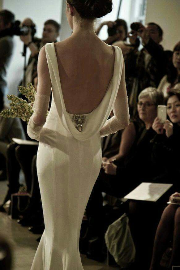 the back of a woman's wedding dress as she walks down the catwalk