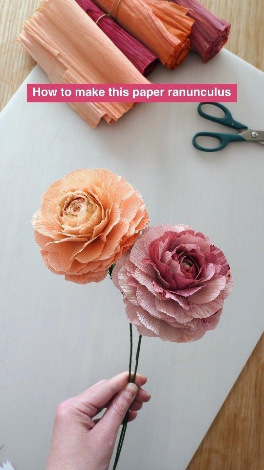 paper flowers are being made with scissors and yarn