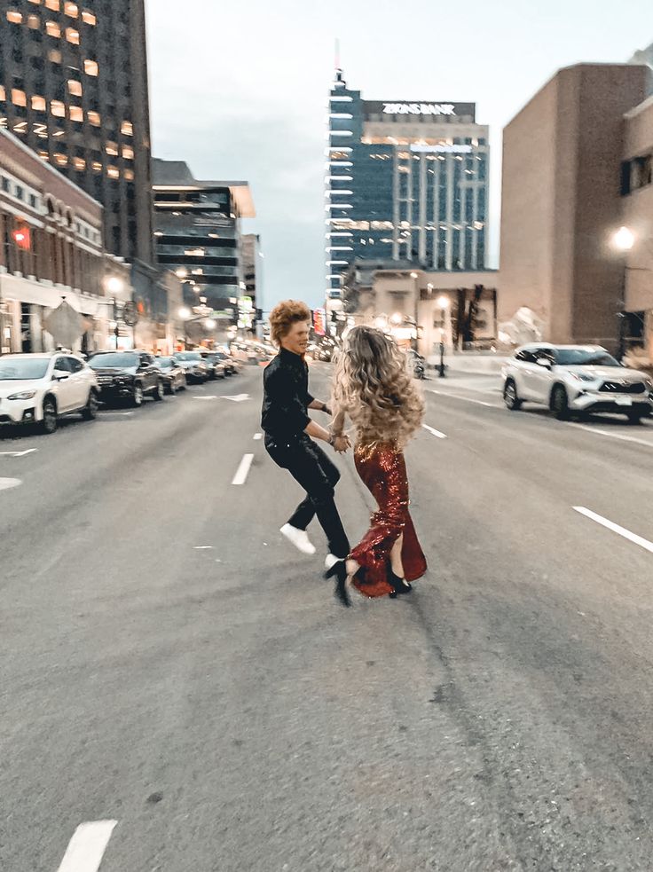 two women walking down the middle of an empty street