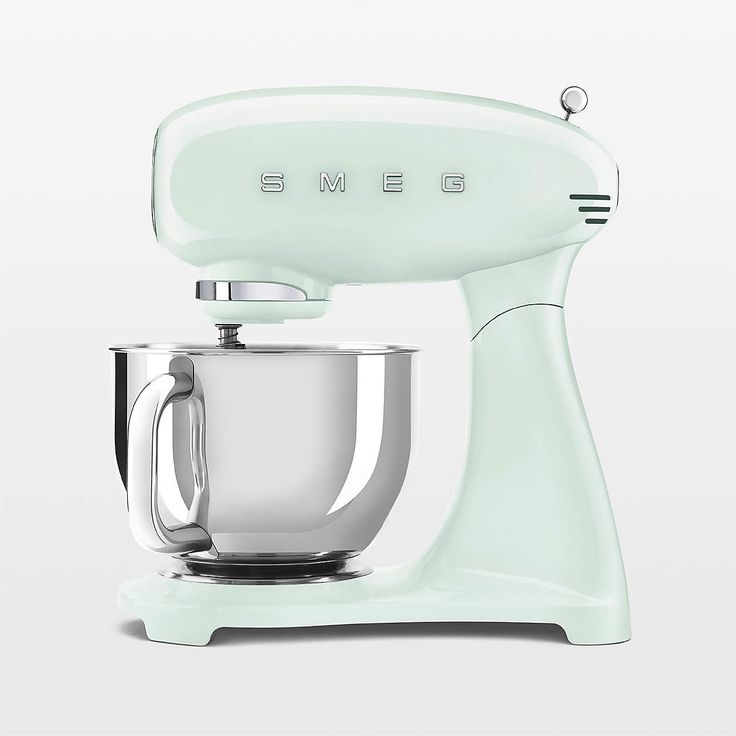 an electric mixer sitting on top of a white table